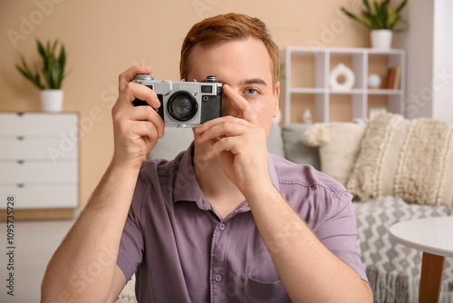 Young man with photo camera...