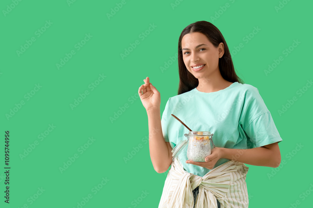 Young woman with chia seed pudding on green background Young woman with chia seed pudding on green background
