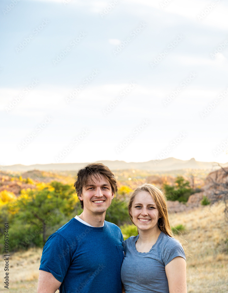 Couple enjoys a joyful moment outdoors in a scenic landscape during golden hour Couple enjoys a joyful moment outdoors in a scenic landscape during golden hour