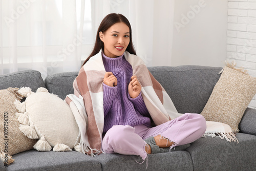 Young woman wrapped in warm...