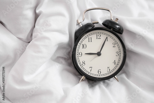 Retro alarm clock on bed, t...