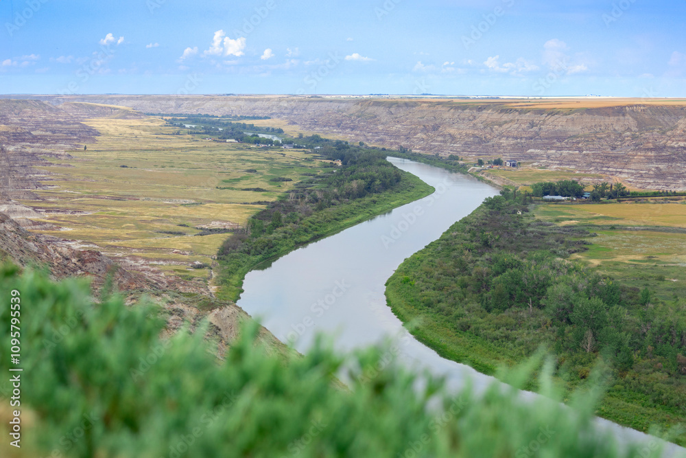 Fototapeta premium View to the river in the valley among badlands from the top of the hill.