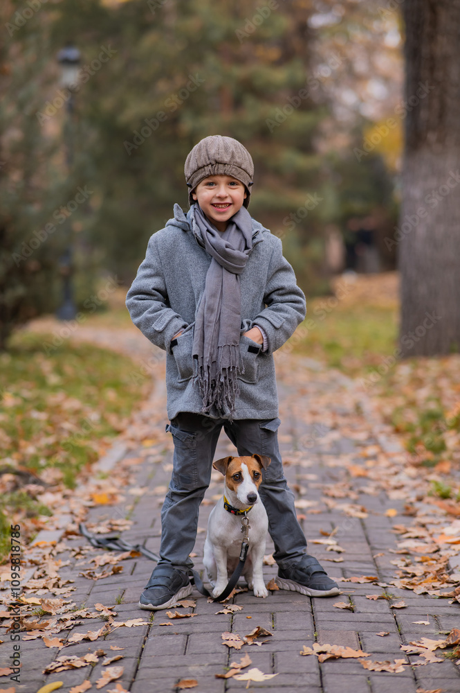 Caucasian boy walking with dog jack russell terrier in autumn park. Caucasian boy walking with dog jack russell terrier in autumn park.
