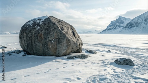 A massive granite boulder sits in a vast white and snowy environment, snowy terrain, natural feature photo