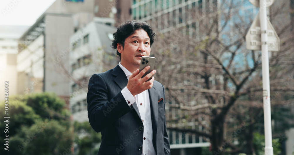Japanese, business and man with phone speaker for discussion, schedule update and negotiation chat. Male person, mobile sound and communication of audio, contact information and urban travel in Japan Japanese, business and man with phone speaker for discussion, schedule update and negotiation chat. Male person, mobile sound and communication of audio, contact information and urban travel in Japan