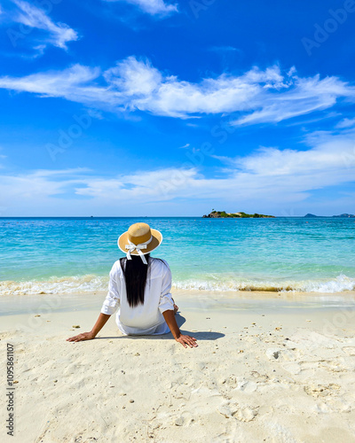 Relaxing on the serene shores of Samae San Island in Thailand under a bright blue sky photo