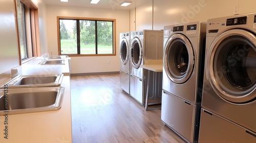 Wallpaper Mural Hostel laundry room, coin-operated washing machines, sleek folding tables Torontodigital.ca