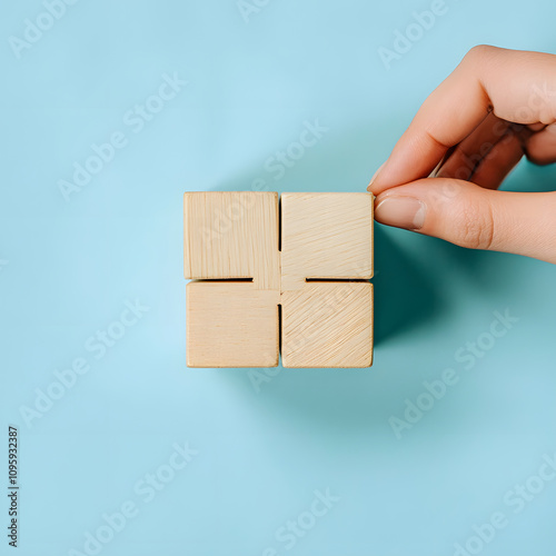 Hand placing a wooden cube minimalist studio product photography indoor space close-up view creative concept for art and design photo