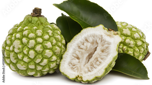 Fresh cherimoya fruits with vibrant green leaves. photo