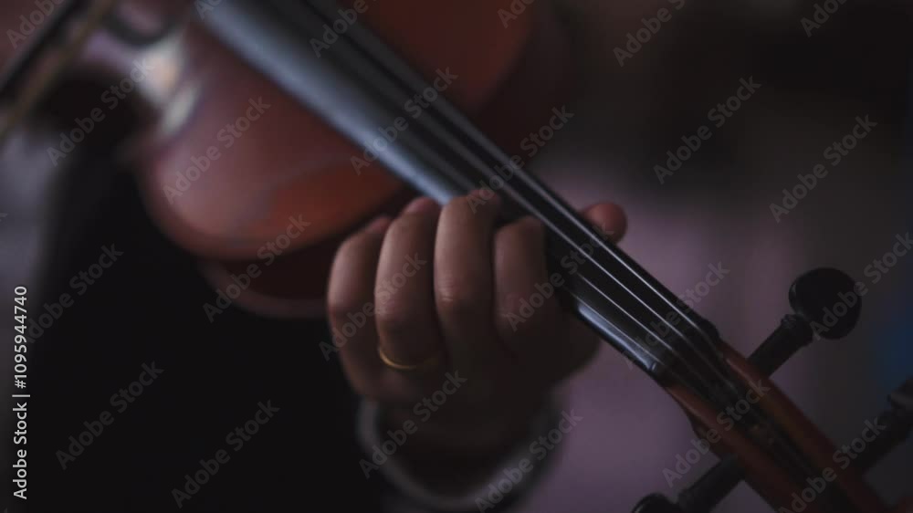 A Musician playing violin at classical or orchestra concert A Musician playing violin at classical or orchestra concert