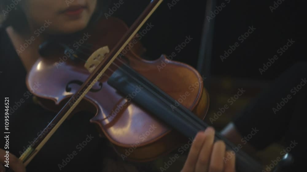 A Cinematic Close-up hand Musician playing violin at classical or orchestra concert with blurry background isolated A Cinematic Close-up hand Musician playing violin at classical or orchestra concert with blurry background isolated