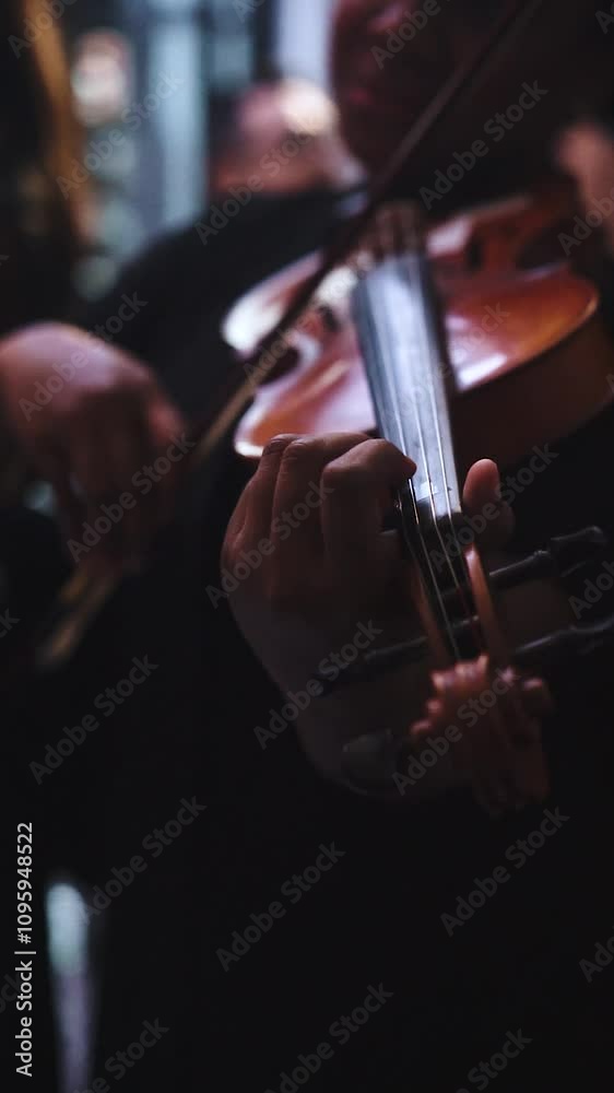 A Cinematic Close-up hand Musician playing violin at classical or orchestra concert with blurry background isolated A Cinematic Close-up hand Musician playing violin at classical or orchestra concert with blurry background isolated