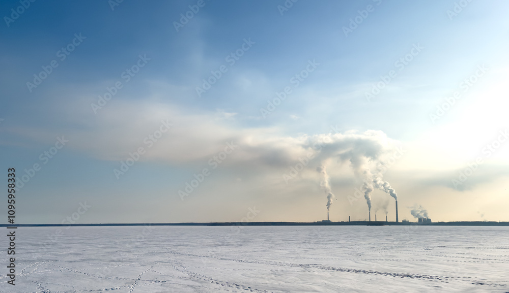A large industrial plant is spewing smoke into the sky A large industrial plant is spewing smoke into the sky