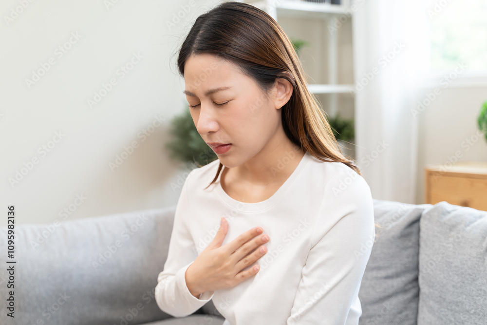 Acid reflux disease, suffer asian young woman have symptom gastroesophageal, esophageal, stomach ache and heartburn pain hand on chest from digestion problem after eat food, Healthcare medical concept Acid reflux disease, suffer asian young woman have symptom gastroesophageal, esophageal, stomach ache and heartburn pain hand on chest from digestion problem after eat food, Healthcare medical concept
