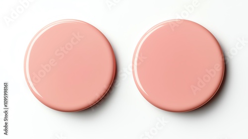 Two glossy pink circular objects arranged symmetrically on a white background, ideal for design and marketing projects. photo