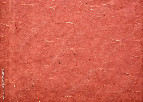 Old red recycled cardboard texture with rustic feel, perfect for backgrounds or crafts. This kraft paper texture adds warmth and character to any project