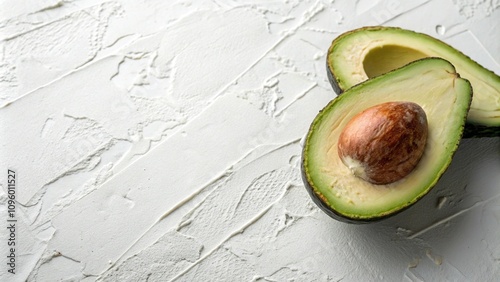 Close-up of half avocado on a textured white background with subtle patterns, , , , avocadonature, fruitcloseup photo