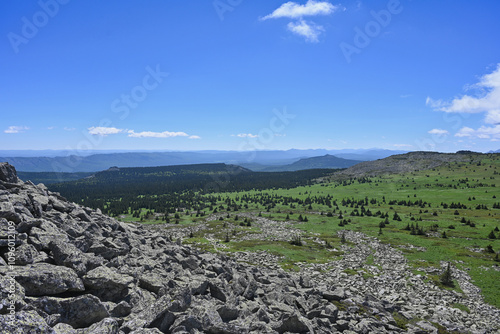 Stone mountain slope with a grass field in Zigalga Nature Park photo