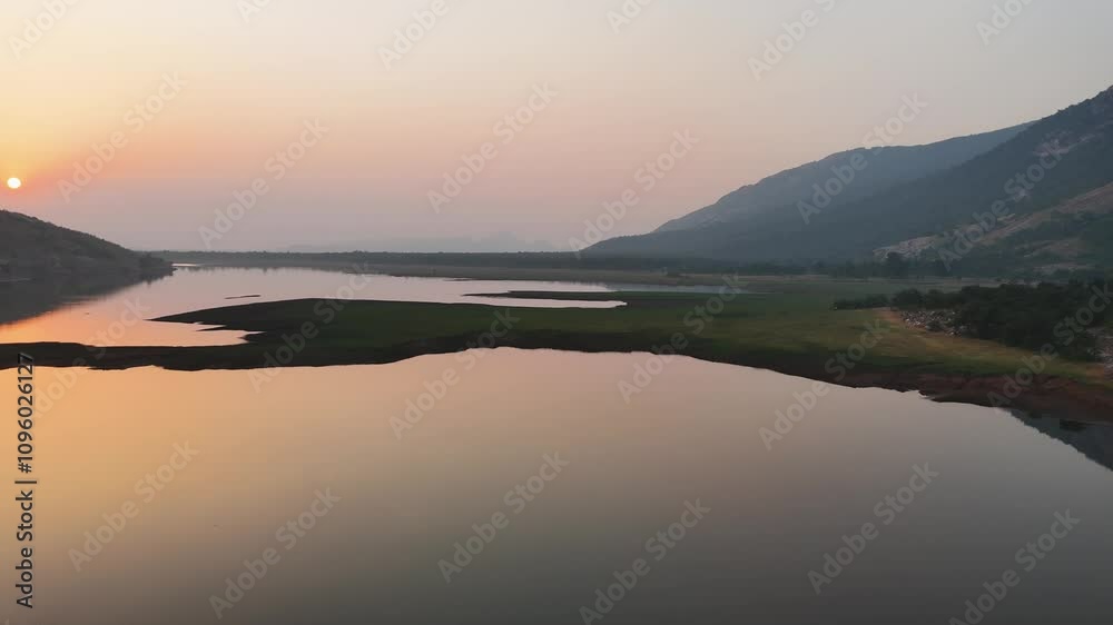 Deori Dam during sunset, Golden hour at Deori Dam Chhattisgarh, Sunset reflection on Deori waterbody, Peaceful evening at Deori Dam, Scenic sunset view of Deori Dam, Aerial sunset over stock video. Deori Dam during sunset, Golden hour at Deori Dam Chhattisgarh, Sunset reflection on Deori waterbody, Peaceful evening at Deori Dam, Scenic sunset view of Deori Dam, Aerial sunset over stock video.