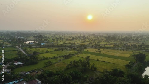 Aerial view of a serene village landscape, Picturesque rural scenery with lush greenery, Drone shot of a vibrant Indian village, Peaceful village with fields and a lake Stock Video. photo