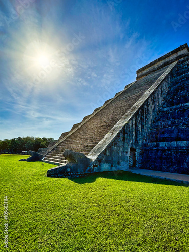 Mayan Feathered serpent god,Kukulcan,represented by the snake carvings on the stairs of the famous Temple Pyramid,that appear to descend during the spring equinox at Chichen Itza,Yucatan,Mexico  photo