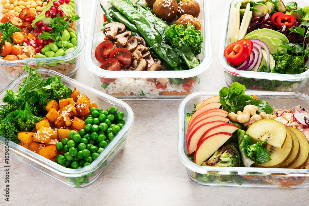 Glass containers with fresh vegan food, ready for meal prepping. Glass containers with fresh vegan food, ready for meal prepping.