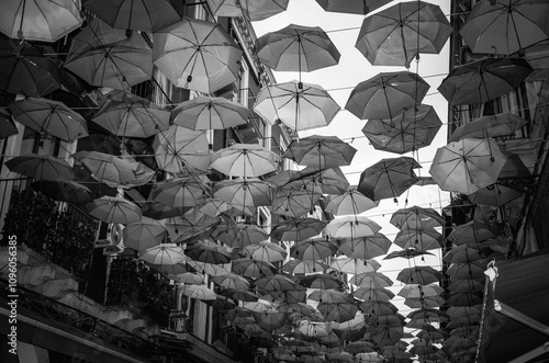 A historic street full of charming restaurants withcolorful umbrellas in Catania photo