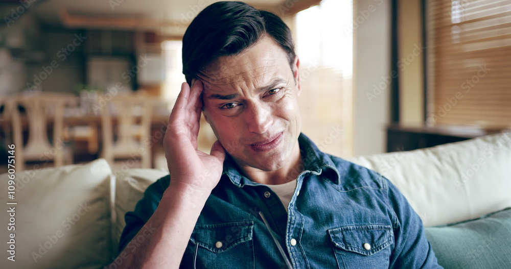 Fototapeta premium Man, portrait and headache in home with stress, sickness and medical condition on sofa. Male person, migraine and pain in living room for emergency, anxiety and massage temple for relief of illness