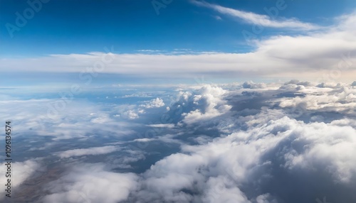 A breathtaking view of the blue sky with wispy clouds as seen from above, blending serene shades of azure and white, evoking tranquility and the wonder of natures untouched beauty in the