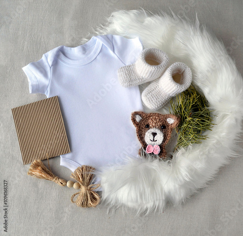 Cute baby Girl or boy Birth announcement template. Pregnancy announcement. Woodland theme. mockup Blank white onesie and  booties.  flat lay. Winter  baby birth announcement. photo