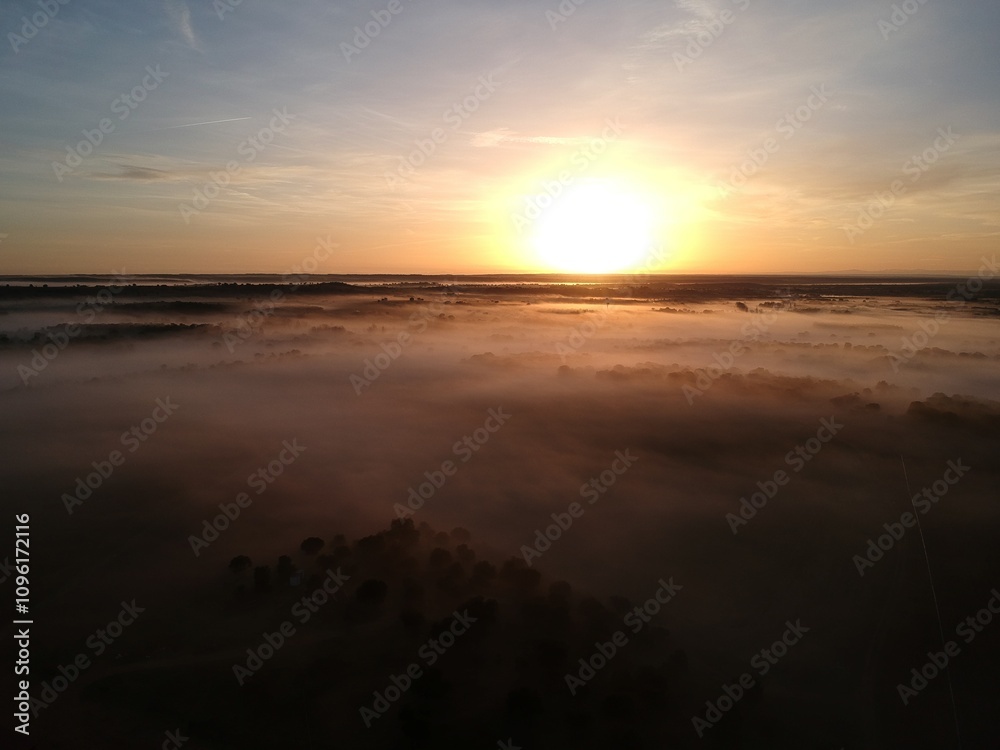 Drone video of a sunrise in the countryside with low fog and an intense yellow sun Drone video of a sunrise in the countryside with low fog and an intense yellow sun