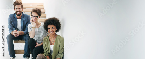 Designers, portrait and smile at wall space for collaboration, ambition and team in banner. Creative people, happy or stairs in office for business growth, startup partnership or about us with mockup photo