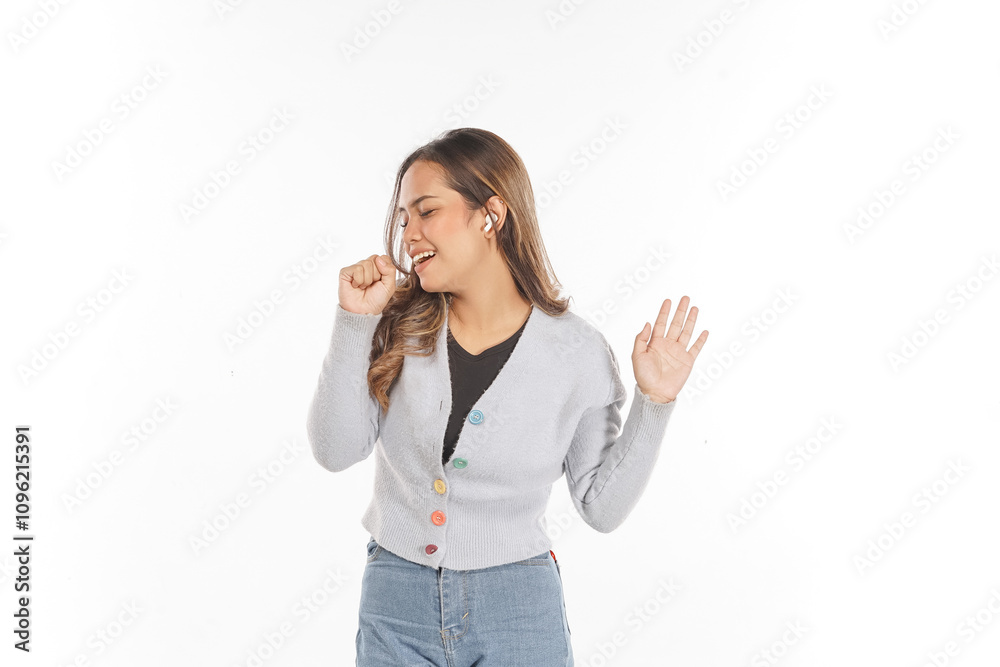 Young Asian woman seems to be singing while listening to music using airpods Young Asian woman seems to be singing while listening to music using airpods