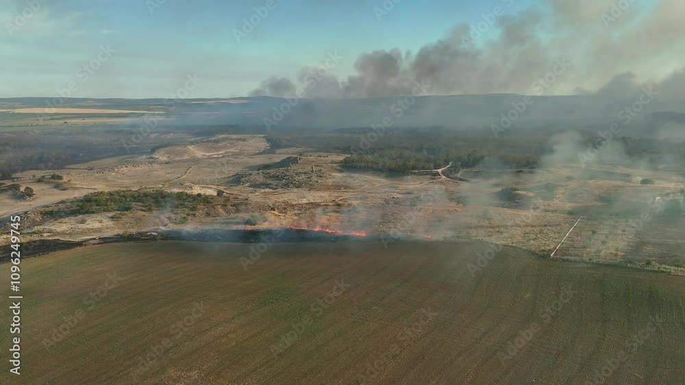 Drone Flight above of dangerous forest fire. Aerial view, Flying over burning bushes woodland from a fire, smoke in the air everywhere. Drone Flight above of dangerous forest fire. Aerial view, Flying over burning bushes woodland from a fire, smoke in the air everywhere.