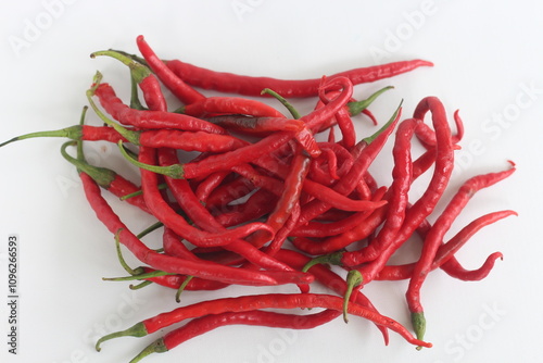 a bunch of fresh curly red chilies isolated on white background. In Indonesia, it is commonly called cabai merah keriting. photo