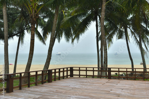 Fototapeta Naklejka Na Ścianę i Meble -  wooden bridge on beach with palm trees