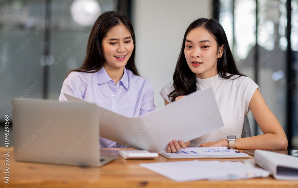 Financial Business two women analyze the graph of the company's performance to create profits and growth, Market research reports and income statistics, Financial and Accounting concept. Financial Business two women analyze the graph of the company's performance to create profits and growth, Market research reports and income statistics, Financial and Accounting concept.