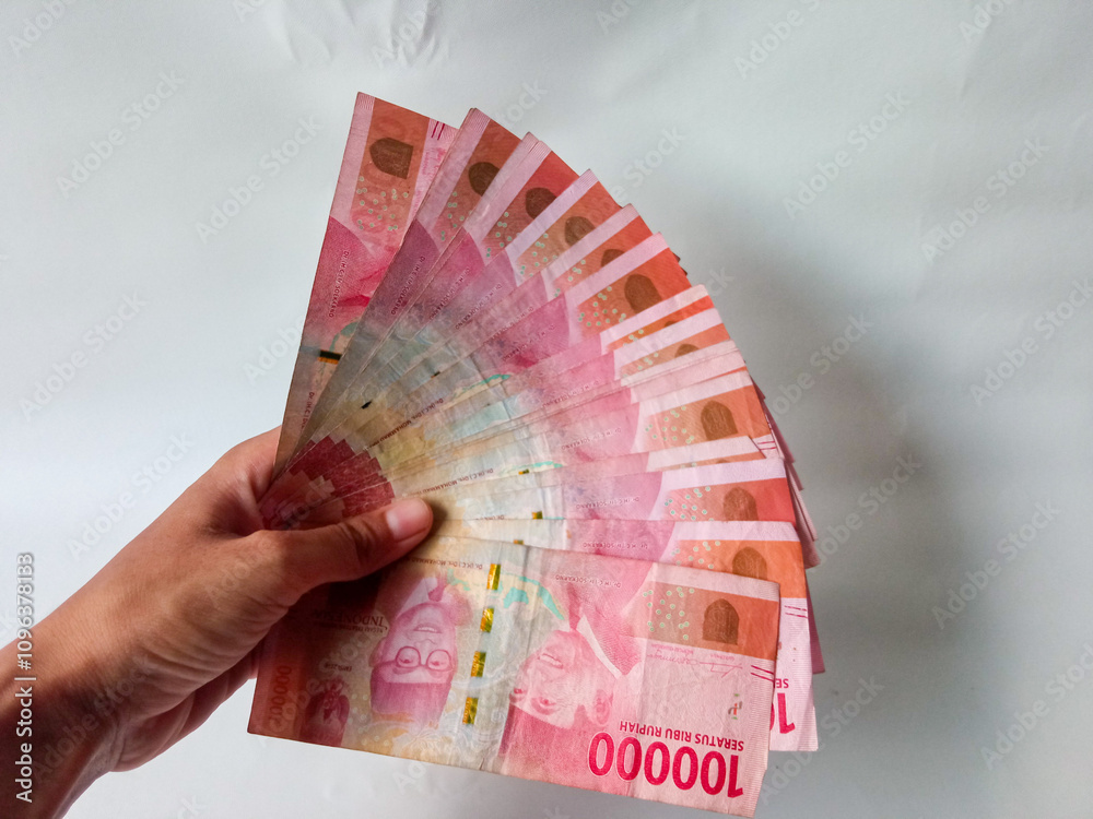 Cash payment concept. Indonesian rupiah currency (Rp. 100.000 Seratus ...