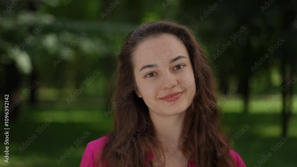 A tranquil and serene portrait capturing the essence of a confident young woman outdoors, donning a vibrant pink jacket A tranquil and serene portrait capturing the essence of a confident young woman outdoors, donning a vibrant pink jacket