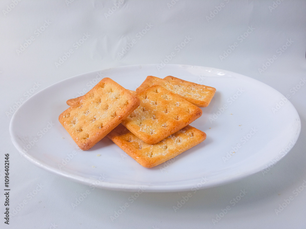 Sugar coated biscuits, also known as malkist, sweet and crispy. Served on white plate