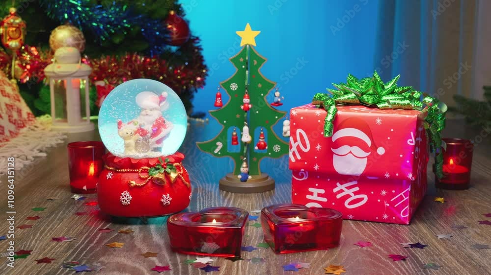 I Love you. Hearts, Red Candles, Love Presents. Christmas Gift Box Next to a Festive Christmas Tree and a Glass Snow Globe with Santa Claus Inside. Perfect Scene for Christmas and New Year Greetings