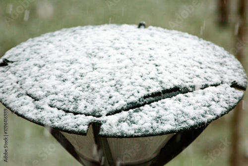 Layer of snow on top of light post in Ettegerpark during Dutch winter photo