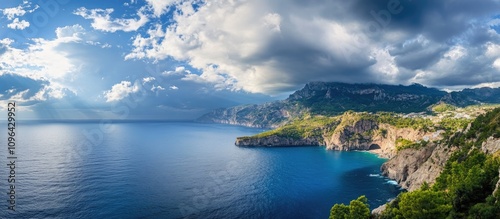 Panoramic coastal landscape with dramatic clouds and serene blue waters contrasting against lush green cliffs