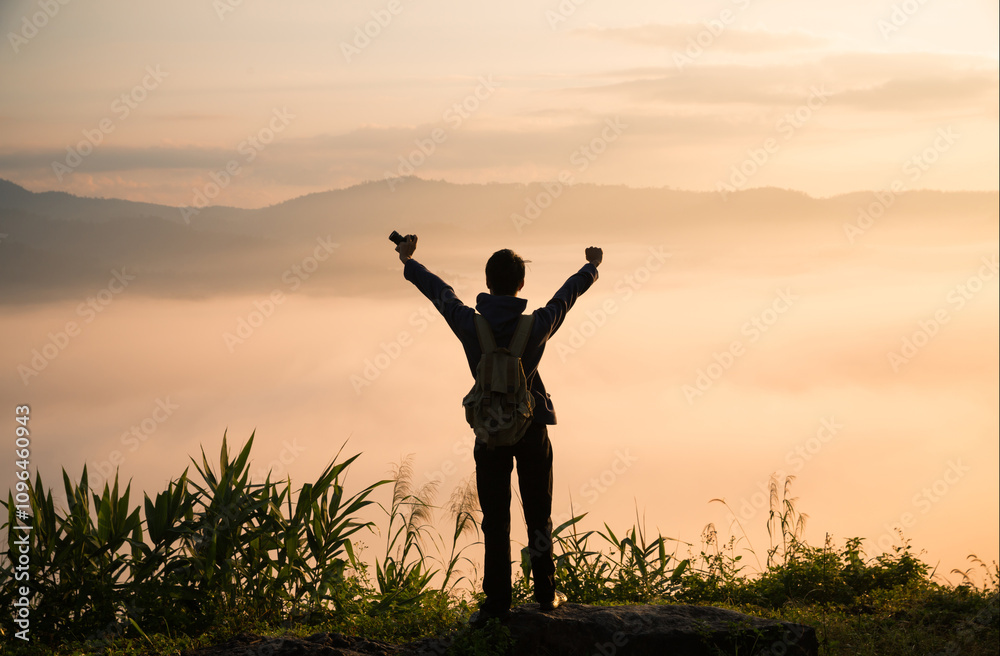 At sunrise, holiday maker embraced adventurous lifestyle of hiking through fog-covered mountains, with a backpack full of essentials and deep appreciation for beauty of nature. travel, sunrise, fog. At sunrise, holiday maker embraced adventurous lifestyle of hiking through fog-covered mountains, with a backpack full of essentials and deep appreciation for beauty of nature. travel, sunrise, fog.