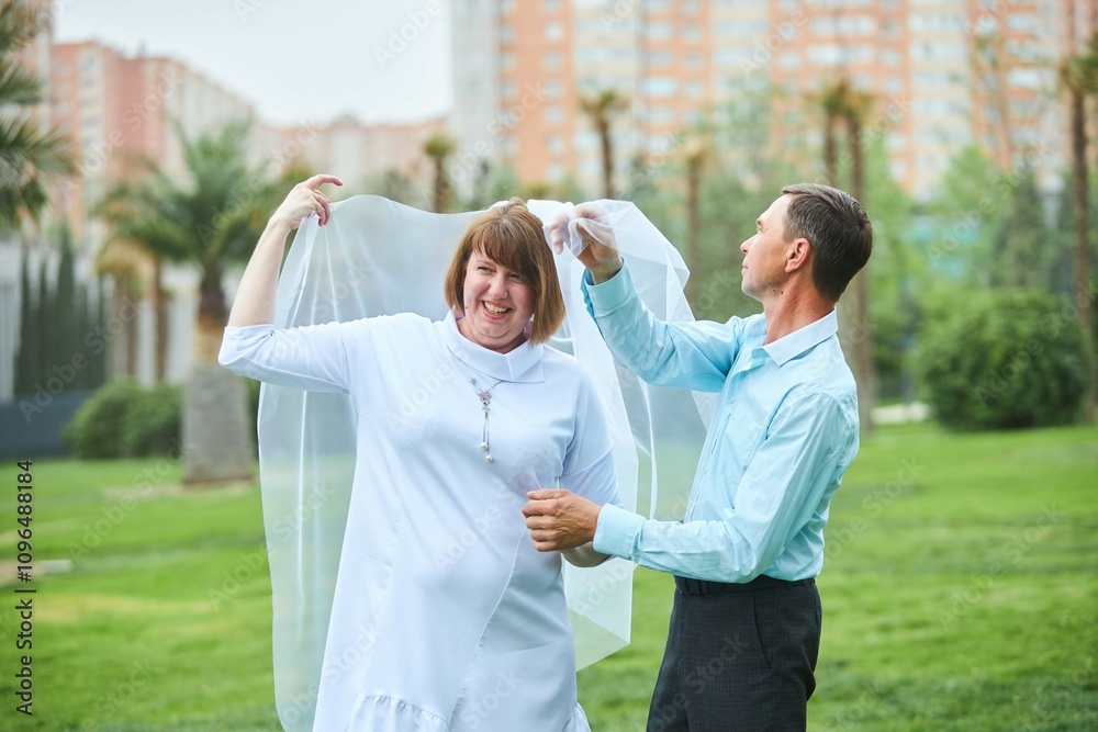 An adult bride and groom. Husband and wife's wedding anniversary photo shoot. We've been together for 30 years. An adult bride and groom. Husband and wife's wedding anniversary photo shoot. We've been together for 30 years.