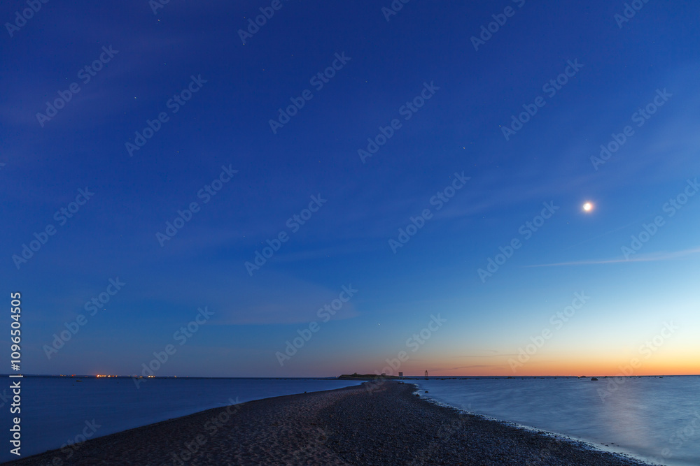 Full moon rising over the Baltic sea, sea shore view, late sunset time Full moon rising over the Baltic sea, sea shore view, late sunset time