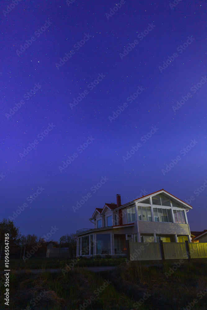 Night clear sky view with starts and wooden house at foreground Night clear sky view with starts and wooden house at foreground