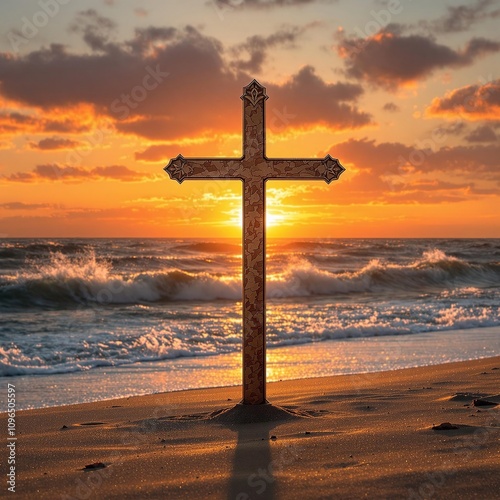 A stunning sunset casts a warm orange glow over a metal cross standing upright in the sand with waves crashing against it , cross, faith, spirituality photo