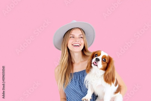 Woman holding dog in blue dress