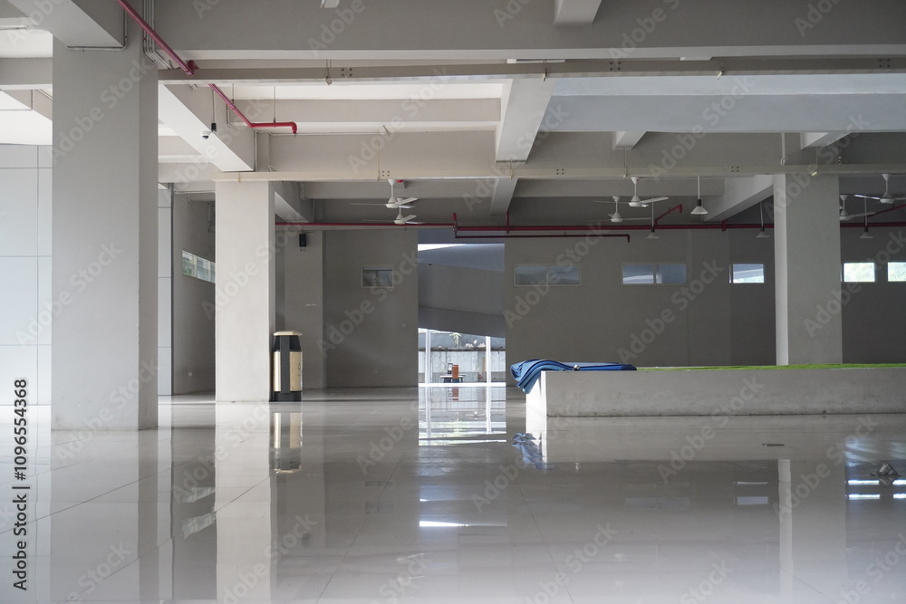 A spacious and empty minimal white room with pillars. A spacious and empty minimal white room with pillars.